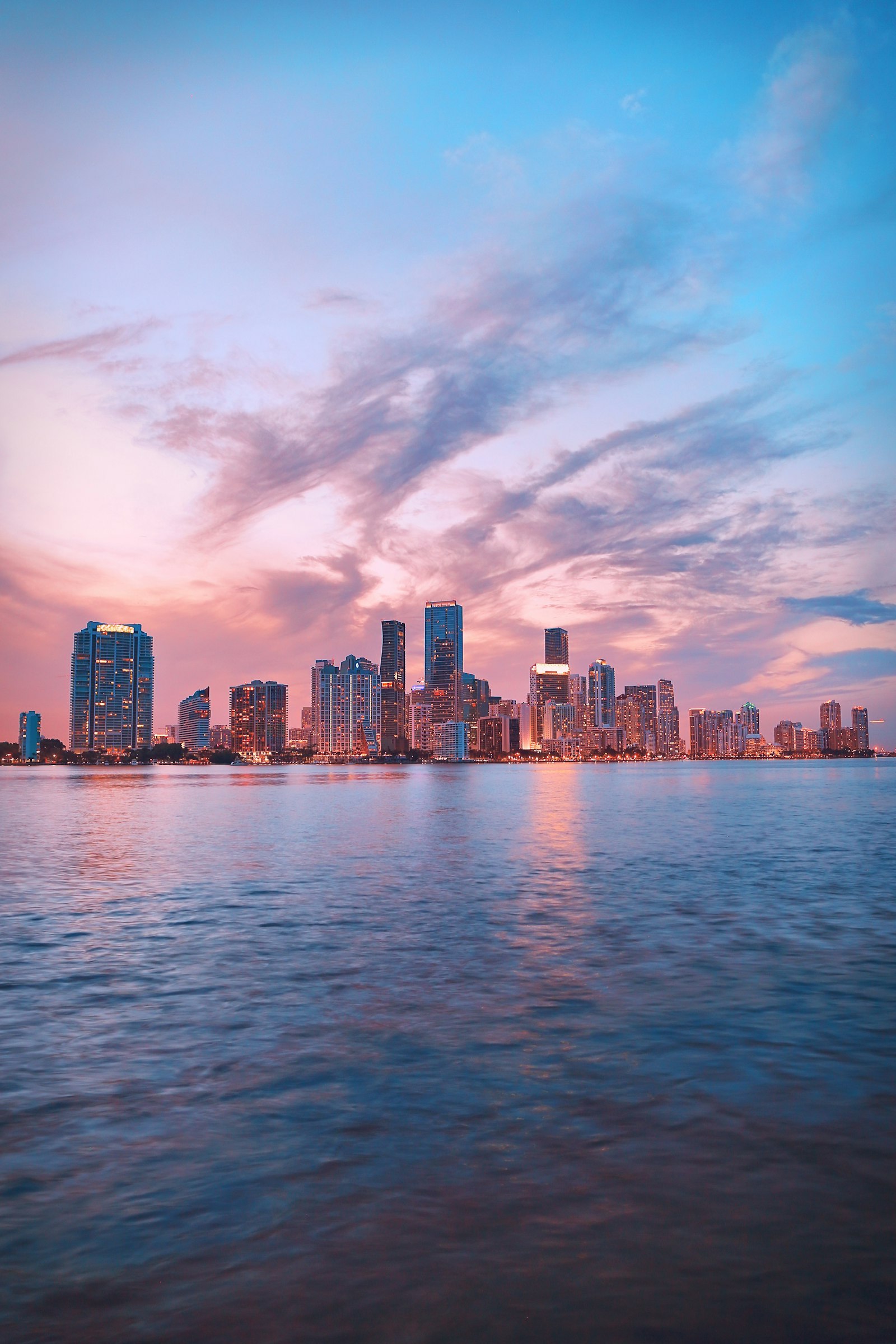 Miami downtown skyline at golden hour reflected over Biscayne Bay